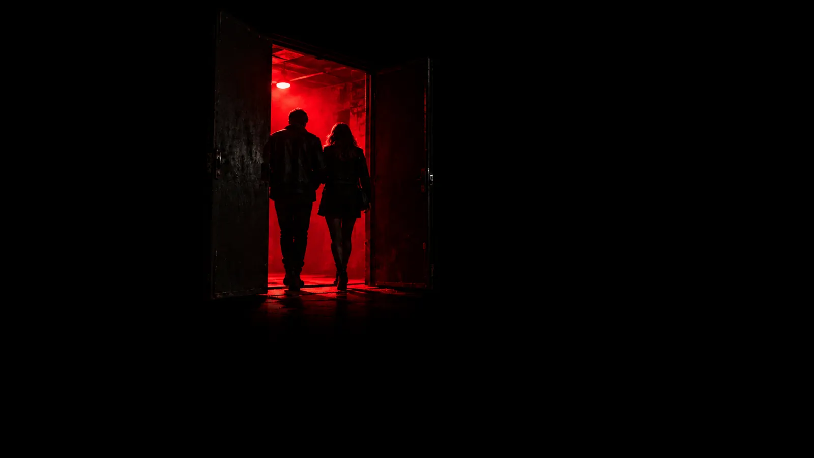 A red-lit club doorway